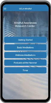 Mobile phone with the UCLA Mindful Coach App on the screen