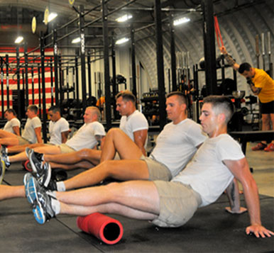 Group of servicemembers in recovery positions after exercise