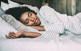 Woman sleeping soundly in bed