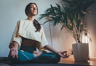 Woman sitting in a relaxing Yoga position