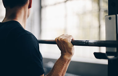 Man preparing to press a barbell above his head