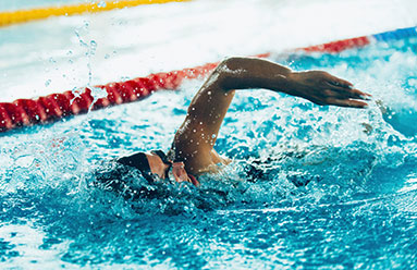 Woman swimming laps in a pool