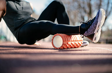 Man foam rolling his calf muscle