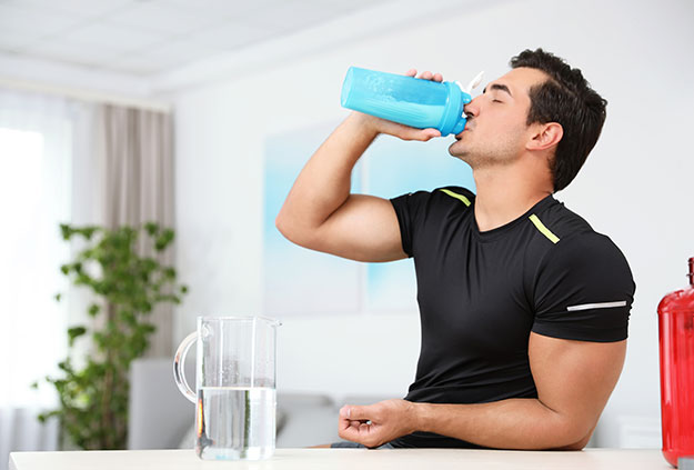 Athletic man is drinking a shake made from whey concentrate