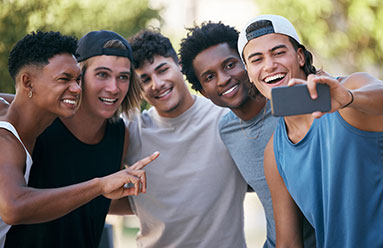 Young men together taking a selfie