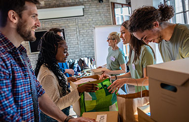 A group of people working together with boxes and bags