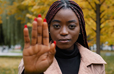 Young woman with her hand up to indicate a boundary