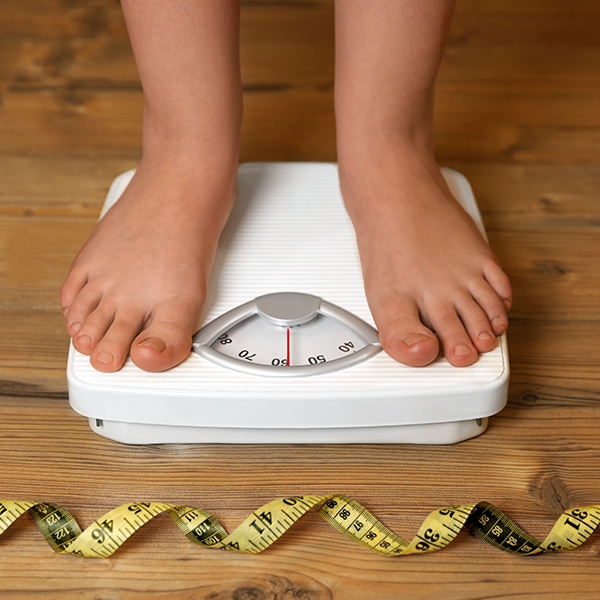 Kid being weighed on a scale